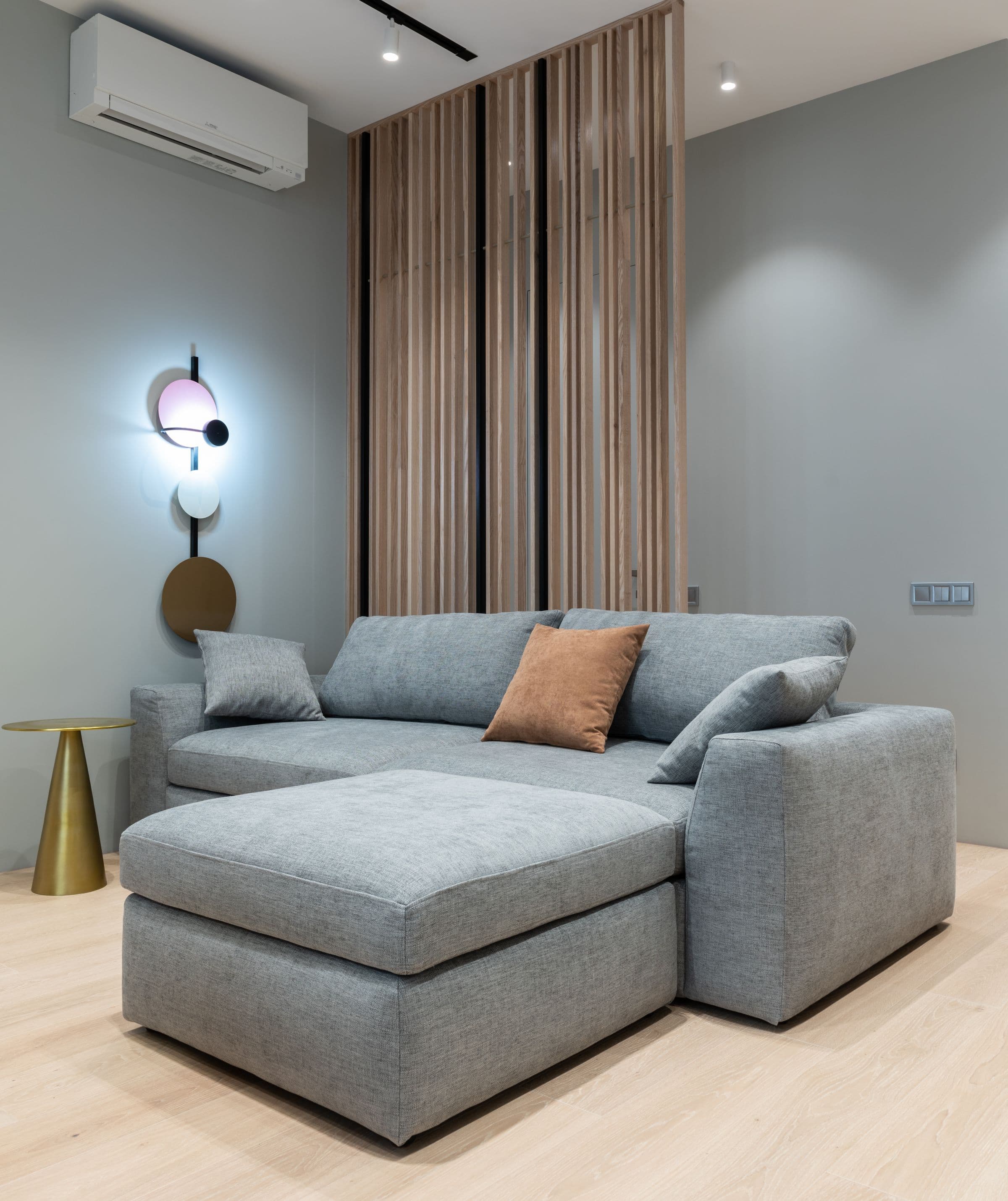 Bright, modern living room with a grey fabric sofa