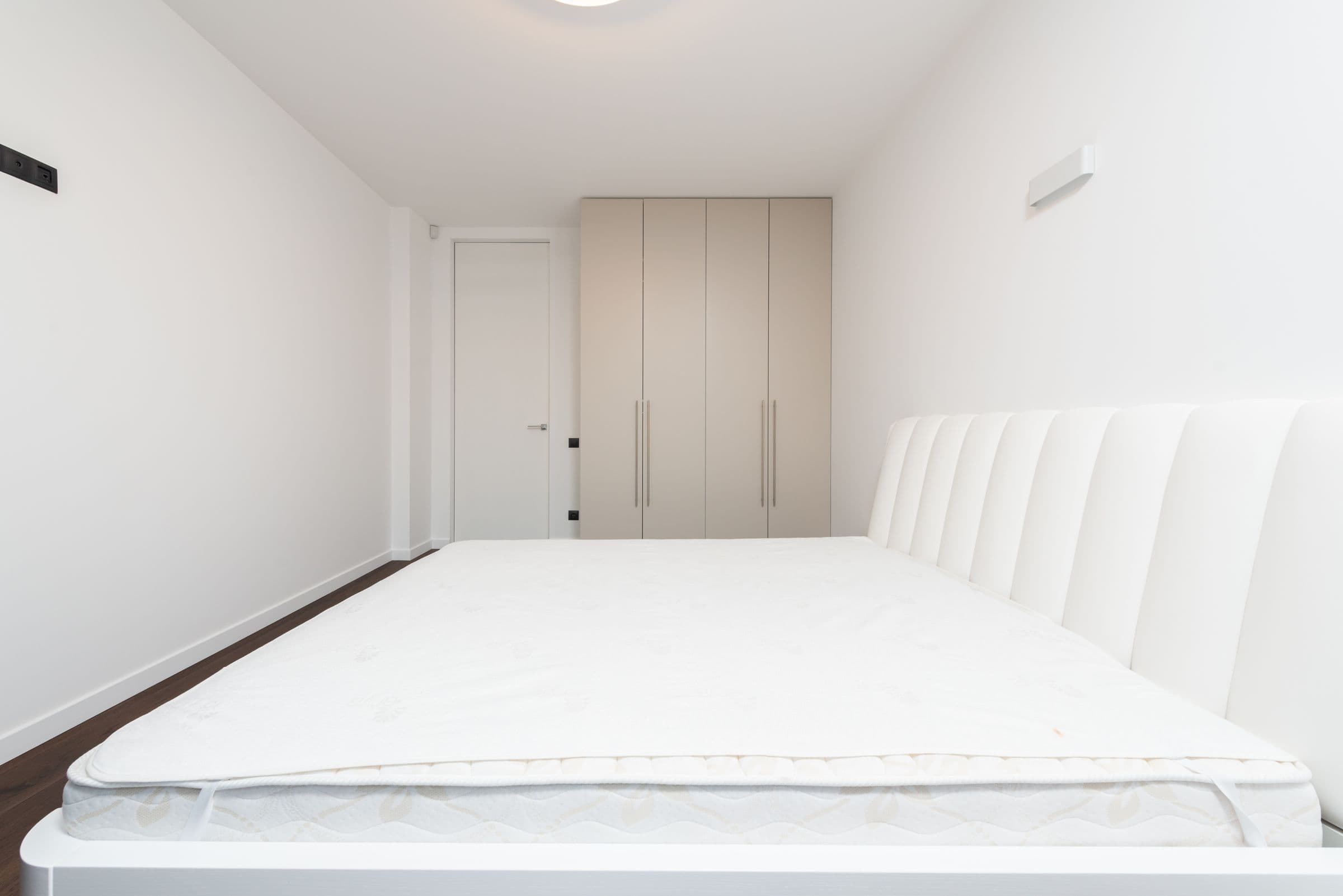 White mattress in a bright bedroom